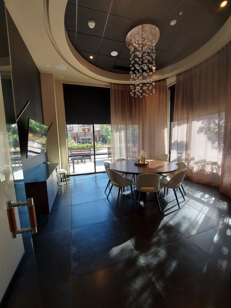 Clean private dining room with polished stone floors and glass doors