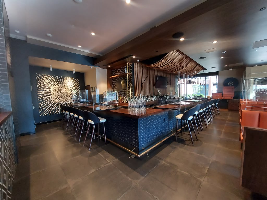 Polished restaurant bar with clean tile floors and wiped counters