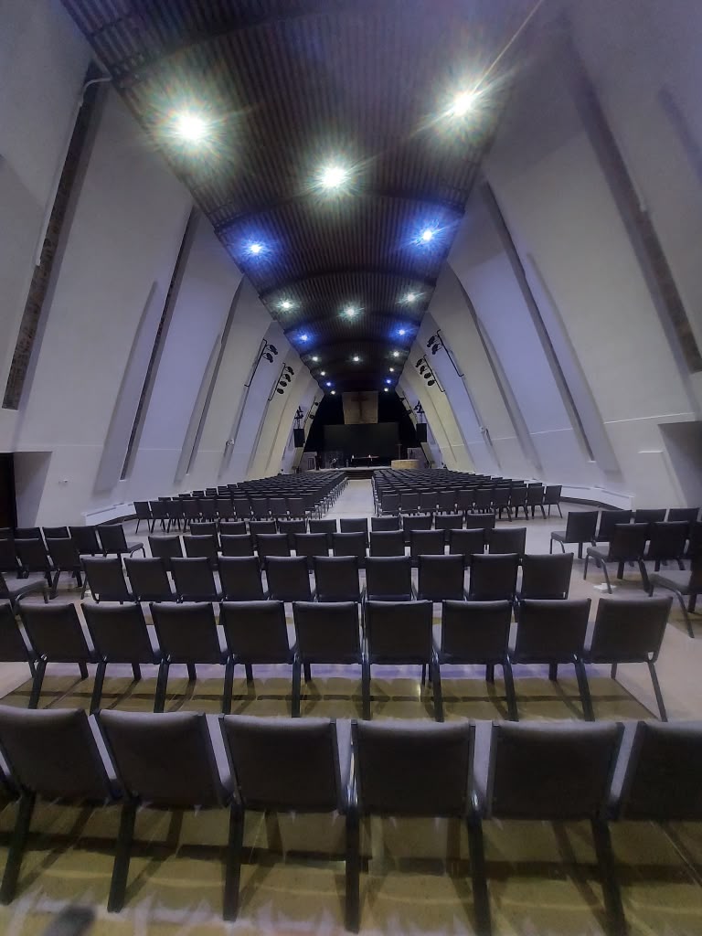 Rows of clean seating in a church sanctuary after service cleaning